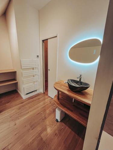 a bathroom with a sink and a mirror at Domaine du Mimosa in Perros-Guirec