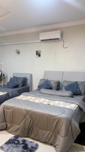 a bedroom with two beds and a heater on the wall at Studio Suites Sani Villa Legacy in Pelabohan Klang