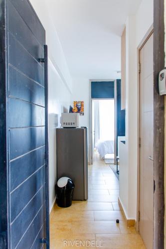 a room with a blue door and a bedroom at Cosy 1BR Apartment along Waiyaki Way, Nairobi in Rungiri