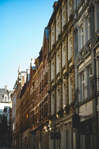 a row of buildings on the side of a street at Hike Inn Hotels by Simonis in Koblenz