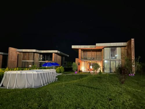 a marquee in front of a house at night at Villa N40 in Kachretʼi