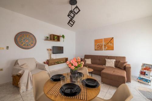 a living room with a table and a couch at Michaella's apartment in Mytilini