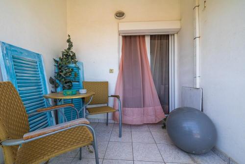 a room with chairs and a table and a window at Michaella's apartment in Mytilini