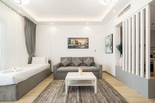a living room with a couch and a table at ZAPBED House - Luxury Holiday Homes in Yas Island in Abu Dhabi