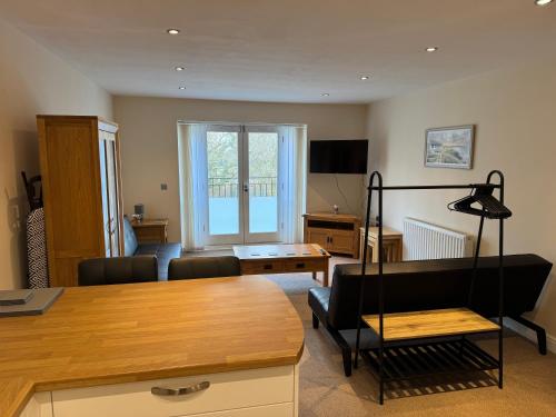 a living room with a couch and a table at Modern, sleeps 5, parking, semi rural, Upholland in Upholland