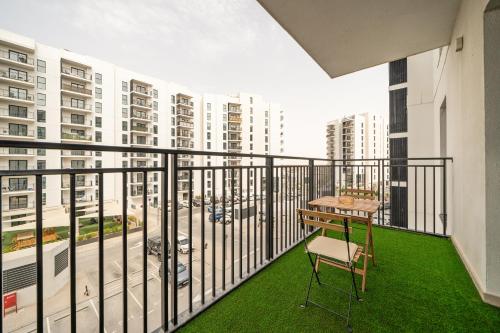 a balcony with a table and a chair on it at ZAPBED House - Luxury Holiday Homes in Yas Island in Abu Dhabi