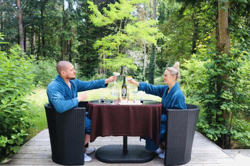 a man and woman sitting at a table drinking wine at Nooz - Something Different? in Grobbendonk
