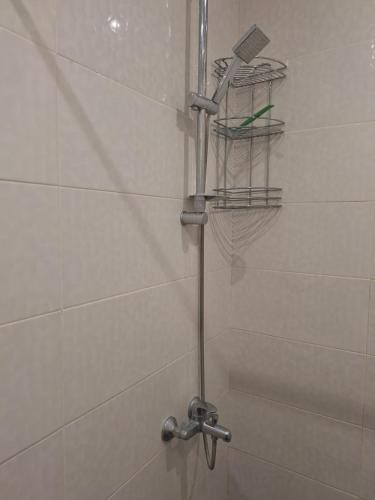 a shower with a faucet in a bathroom at Cozy Apartment in the City Centre in Yerevan