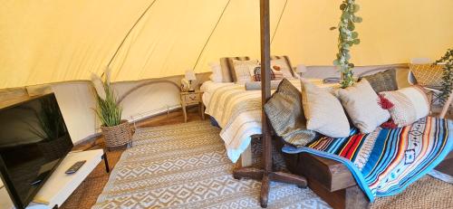 a bedroom with a bed in a tent at Luxury Bell tent Glamping near Yorkshire Wolds in Pocklington