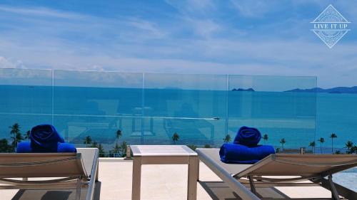 two chairs with blue cushions sitting next to a table at Santi Pura Villas in Koh Samui 