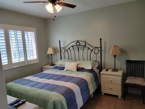 a bedroom with a bed and a ceiling fan at 1 Bed Beach Bungalow #130 in Carpinteria