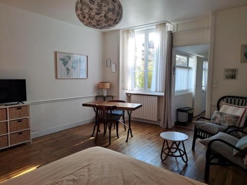 a living room with a table and a couch at Studio plein centre in Dol-de-Bretagne