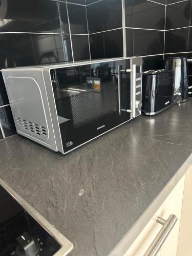 a microwave on a counter in a kitchen at Apartment in MediaCity in Manchester