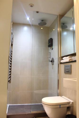 a bathroom with a toilet and a shower at Apartment in MediaCity in Manchester