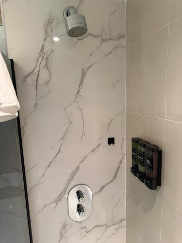 a bathroom with a marble shower stall with a sink at Apartment in MediaCity in Manchester