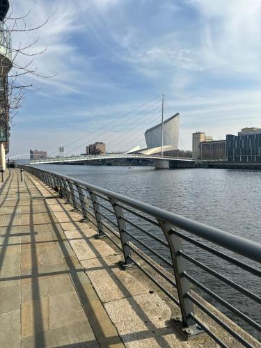a bridge over the water next to a river at Apartment in MediaCity in Manchester