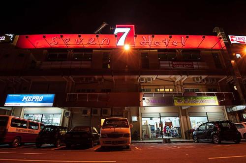 a building with cars parked in front of it at Seven Hotel in Putatan