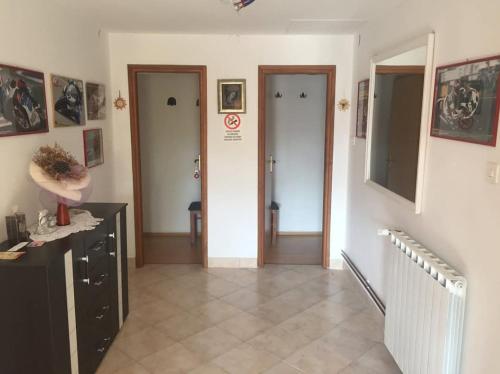 a hallway with two doors and a tile floor at Apartman Antonia in Podhum