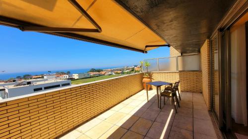 a balcony with a table and a view of the ocean at Casa da Praia in Vila Nova de Gaia