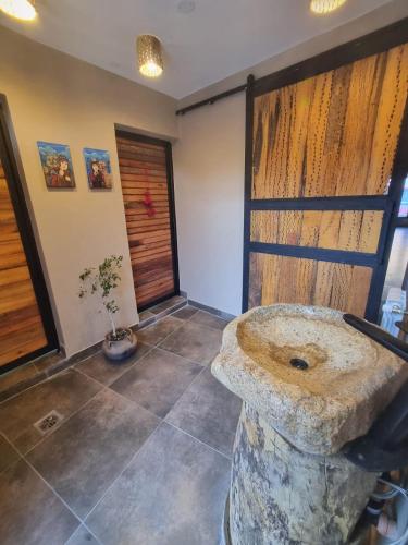 a bathroom with a stone sink in a room at Hotel y Restaurante Winu Maimara in Maimará