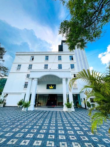 a white building with a sign on it at CROWN REGENCY- BADULLA in Badulla