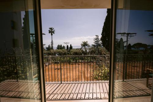 a sliding glass door with a view of a yard at Hotel Villa Paradiso in Taormina