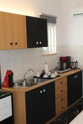 a kitchen with a sink and a counter top at Κatholikis Room in Kremasti