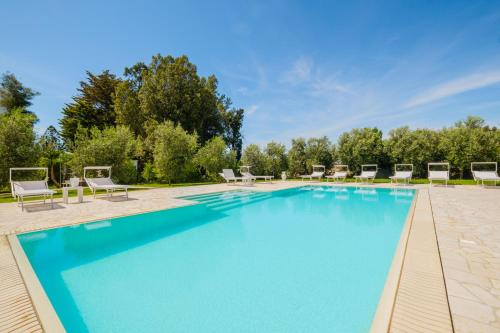 a large swimming pool with lounge chairs around it at Villa Colabati - Private Pool near Gallipoli in Alezio