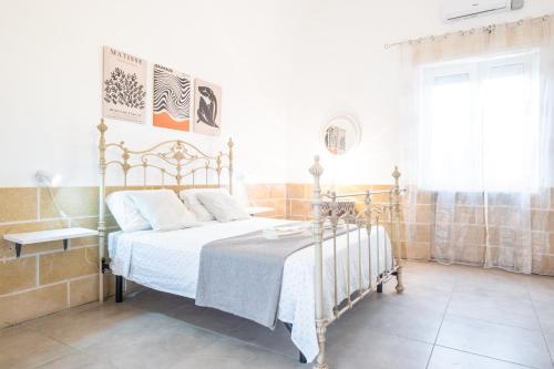 a bedroom with a bed in a room with a window at Villa Colabati - Private Pool near Gallipoli in Alezio