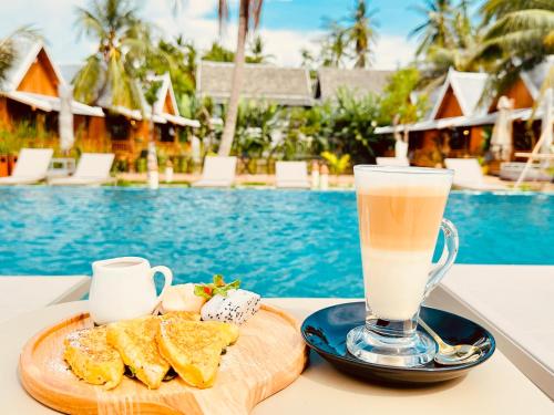 a drink on a table next to a plate of food at The Jam Boutique Hotel in Luang Prabang