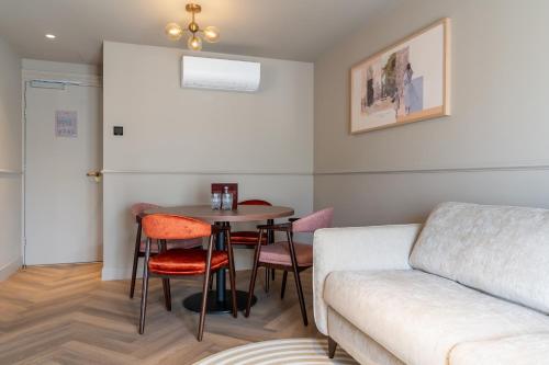a living room with a couch and a table at Malie House in Utrecht
