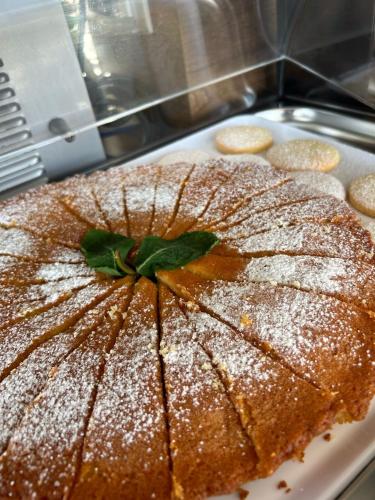 a cake sitting on top of a white plate at Middle Town Palace in Tropea