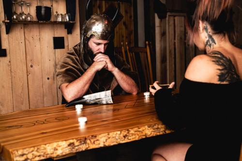 a man wearing a helmet sitting at a table with a woman at Les Toits Du Monde in Nominingue