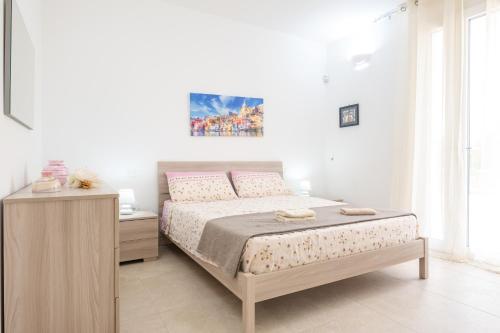 a bedroom with a bed and a nightstand and a bed sidx sidx sidx sidx at Villa Colabati - Private Pool near Gallipoli in Alezio