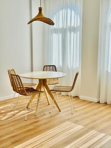a dining room with a table and chairs at Glamour Apartments in Figueira da Foz
