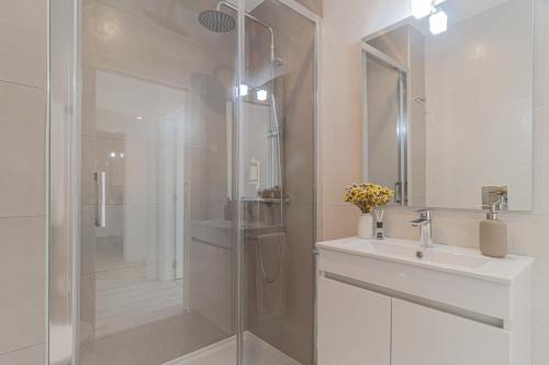 a bathroom with a shower and a sink and a shower at Caminho Real Guest Apartment I in Nazaré