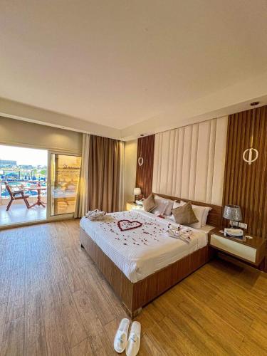 a hotel room with a large bed and a balcony at Ramage Hotel & Resort in Cairo