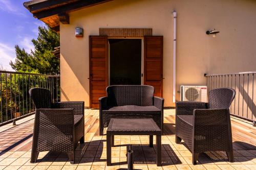 a group of chairs sitting on a deck at Casa Jo - Country Home with Sea View and 3 Private Ensuite Rooms in Lapedona