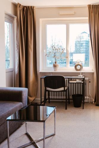 a living room with a table and a window at Lycksele Inn in Lycksele