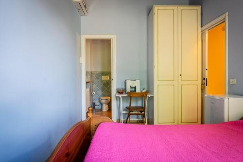 a bedroom with a bed with a pink blanket at Casa Jo - Country Home with Sea View and 3 Private Ensuite Rooms in Lapedona