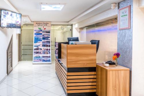 a shop with a reception desk and a vase of flowers at Appart hotel tanger in Dakhla