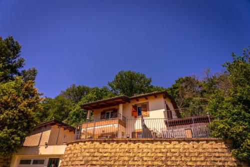 a house on top of a stone wall at Casa Jo - Country Home with Sea View and 3 Private Ensuite Rooms in Lapedona