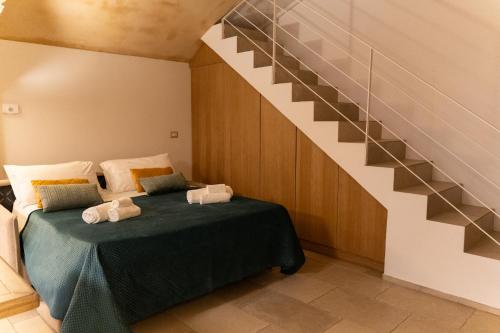 a bedroom with a bed and a staircase at Casa Dogana in Gallipoli