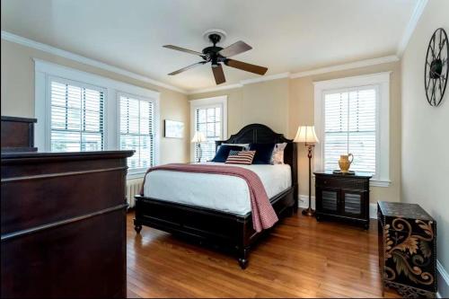 a bedroom with a bed and a ceiling fan at Historic Row Home 1 Block from Gate 1 at USNA in Annapolis