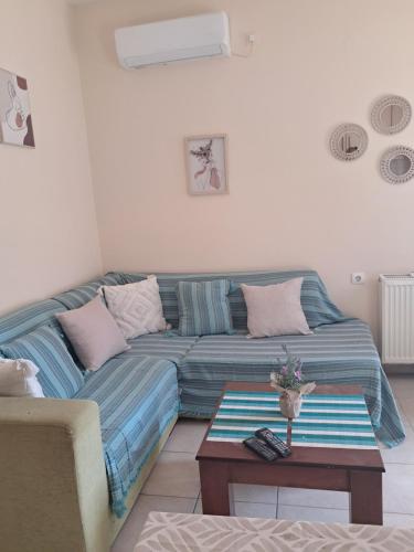 a living room with a couch and a table at Liberty Cozy Apartment in Kalloni
