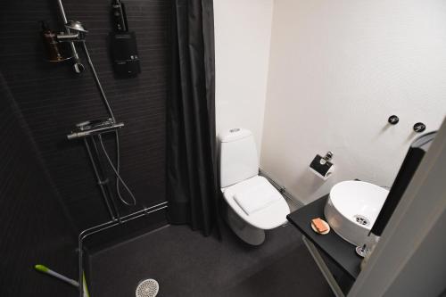 a bathroom with a shower with a toilet and a sink at Lycksele Inn in Lycksele