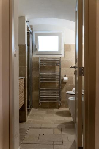 a bathroom with a toilet and a window at Casa Dogana in Gallipoli
