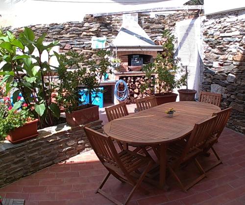 a wooden table and chairs on a patio at Al Martin Pescatore in Stintino