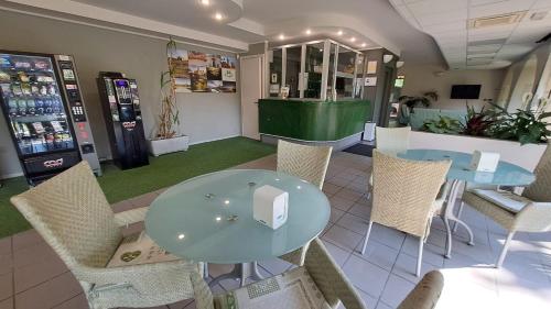 a dining room with a table and chairs in a store at Ducathotel in Torrile