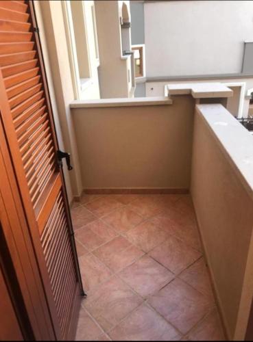 an empty kitchen with a window and a tile floor at SUNRISE SARDINIA Olbia in Olbia